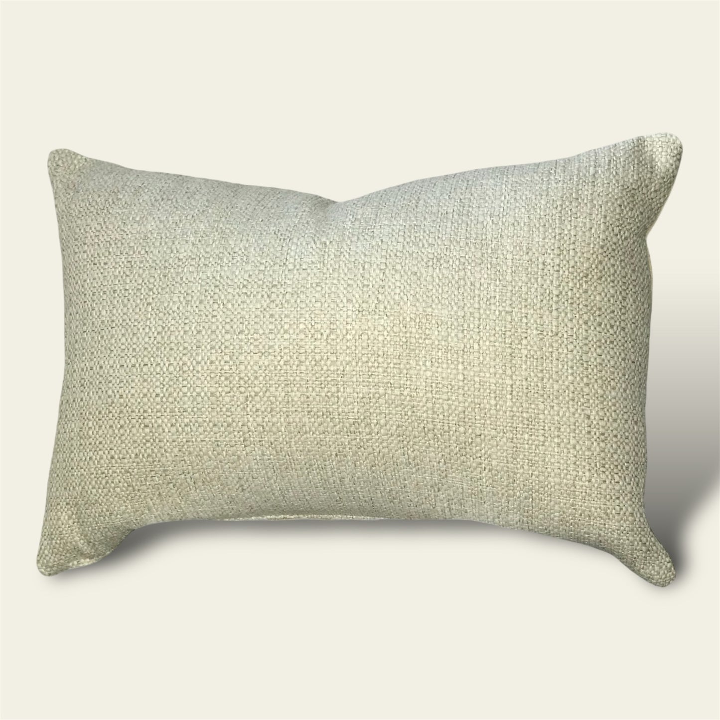 a textured woven cushion cover in a warm oatmeal shade 